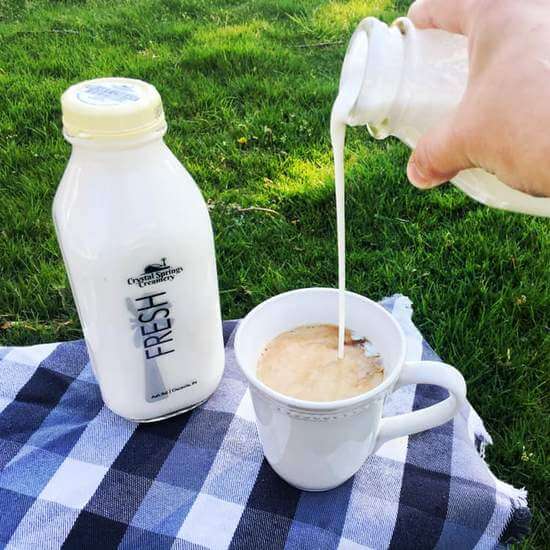 Pouring milk in mug